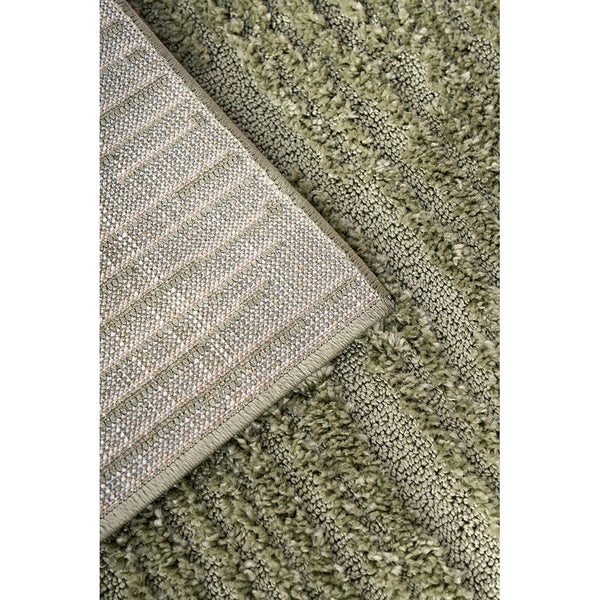 Emerald green textured modern rug with thick polyester pile and subtle woven pattern on backing.