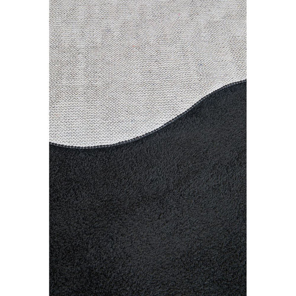 Modern runner rug with black and light gray wave pattern, textured polyester surface.