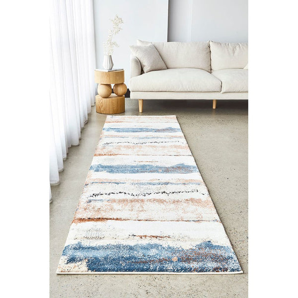Blue, tan, and cream abstract modern runner rug with textured pattern on light floor.