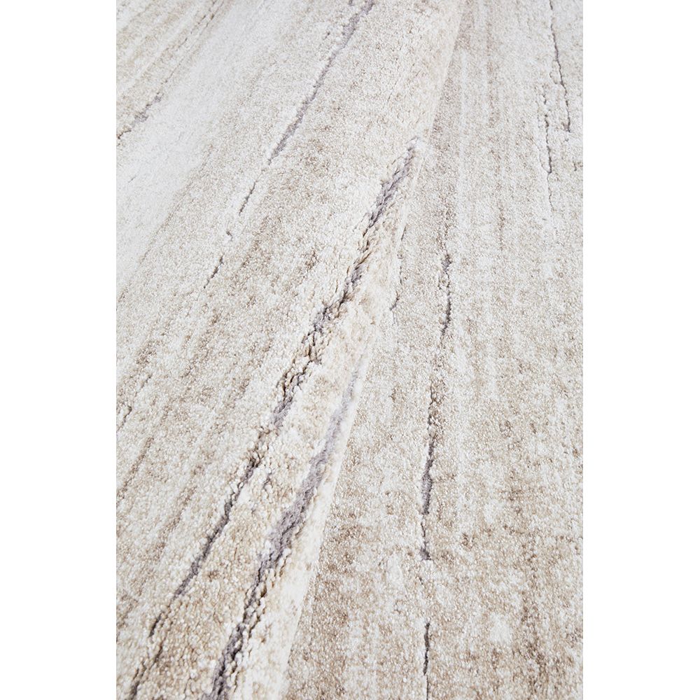 Close-up of a textured beige surface with subtle variations