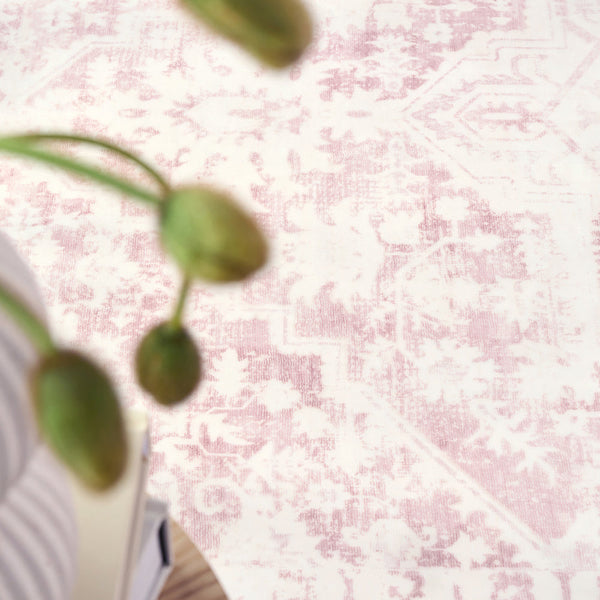 Soft pink and blush rose quartz area rug with subtle modern distressed pattern.