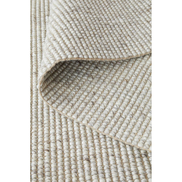 Beige wool jute runner rug with textured hand-loomed weave and natural fibers.
