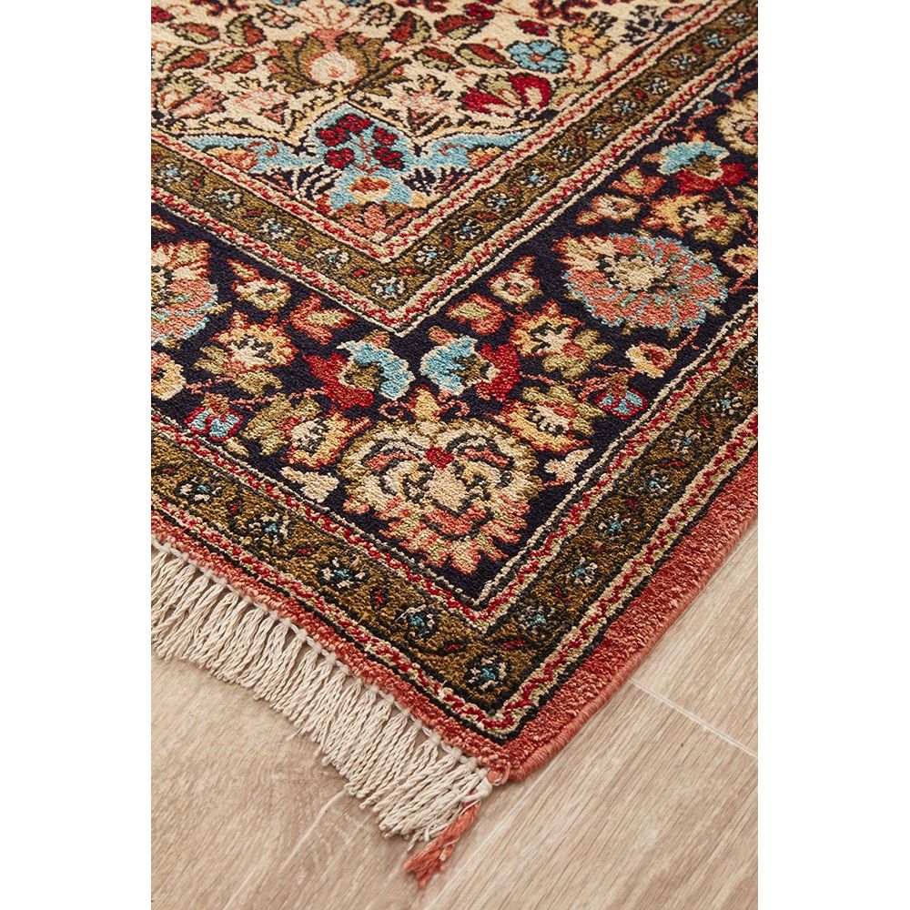 Decorative hand knotted Persian silk rug with intricate patterns on a wooden floor