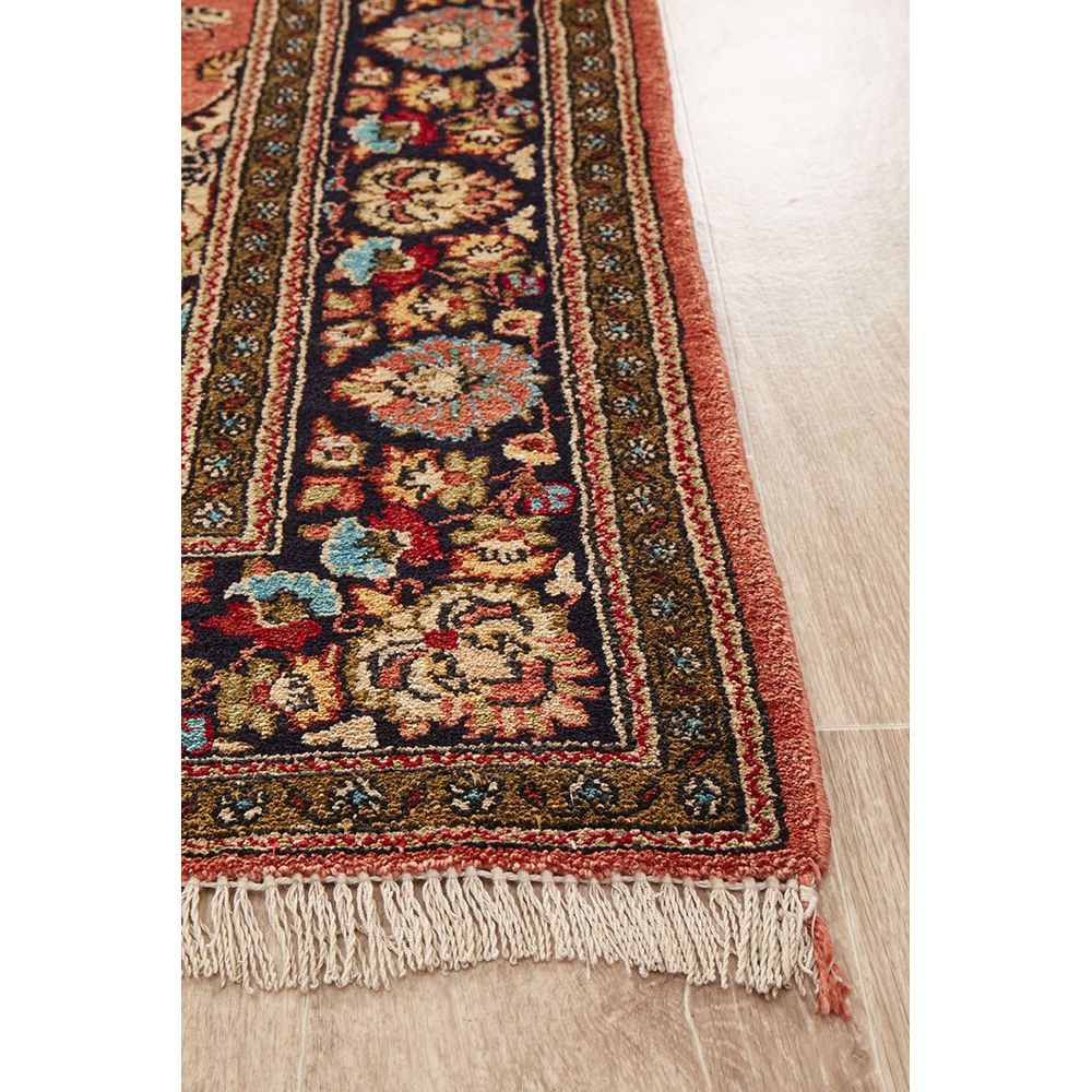 Decorative hand knotted Persian silk rug with intricate patterns on a wooden floor
