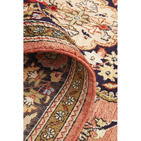 Close-up of a patterned hand knotted Persian silk rug with intricate motifs.