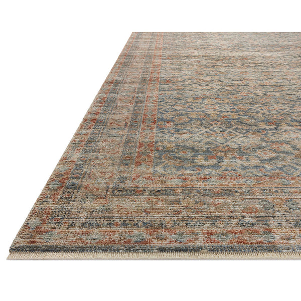 Blue earth-toned rug with multi-colored textured pattern and distressed transitional design.