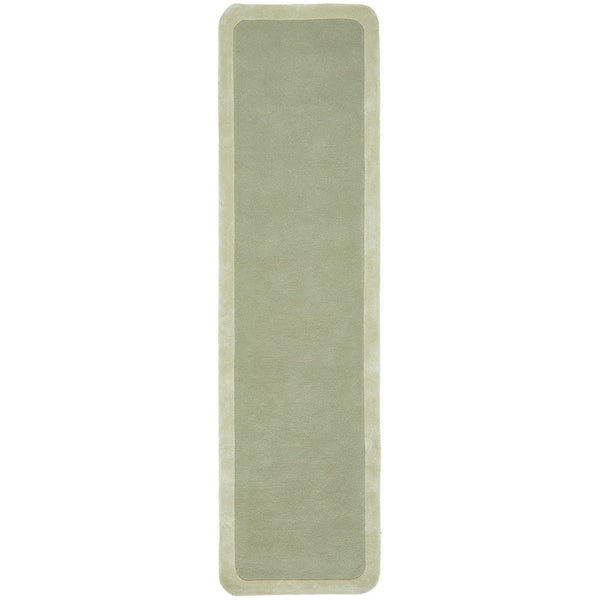 Soft green hand-tufted wool viscose rug with curved border, modern runner design.