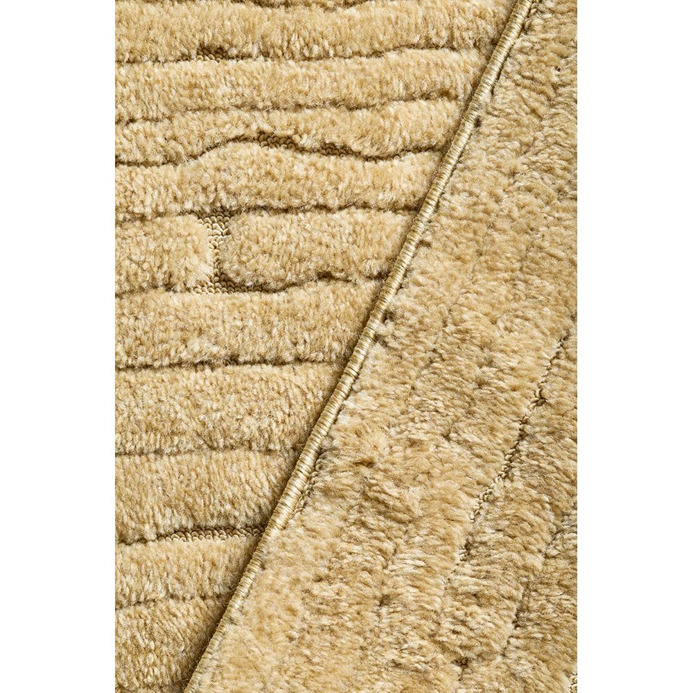 Close-up of textured gold coloured rug