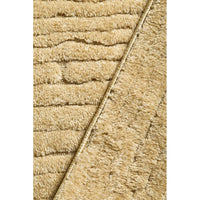 Close-up of gold textured fabric with a diagonal line