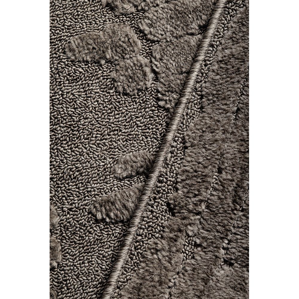 Close-up of textured brown rug with a woven pattern