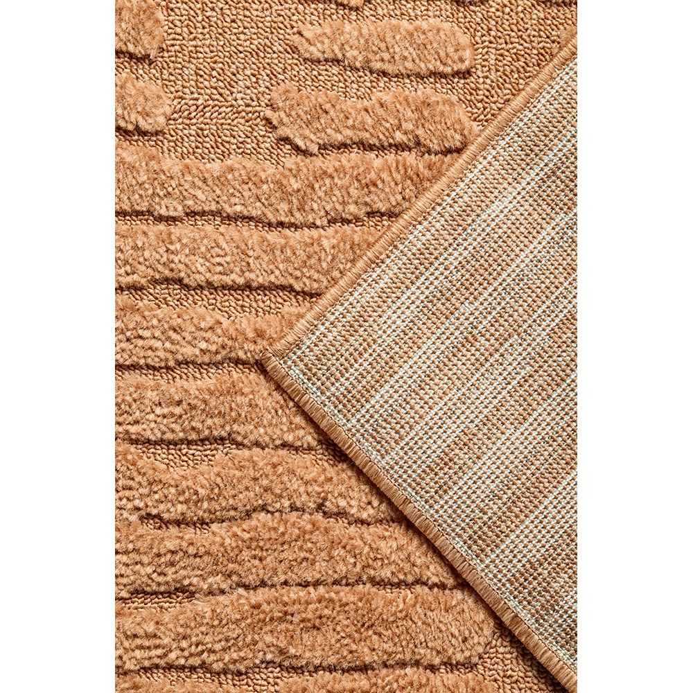 Close-up of a textured rust coloured rug with a geometric pattern