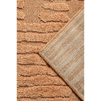 Close-up of a textured rust coloured rug with a geometric pattern