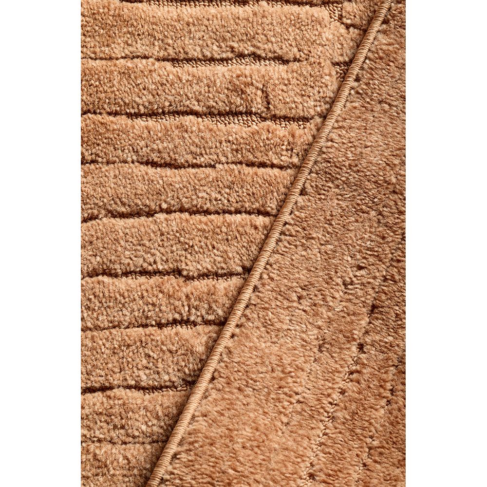 Close-up of a textured rust coloured rug with a diagonal pattern