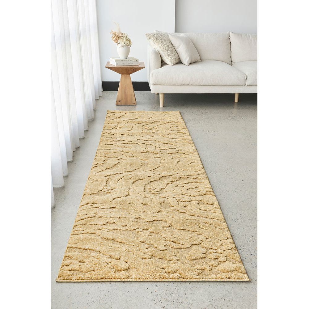 Gold textured runner rug on a light gray floor in a living room setting.