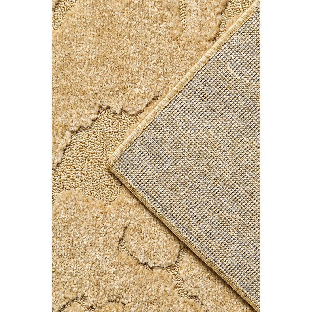Close-up of a gold textured rug corner with a metallic border.