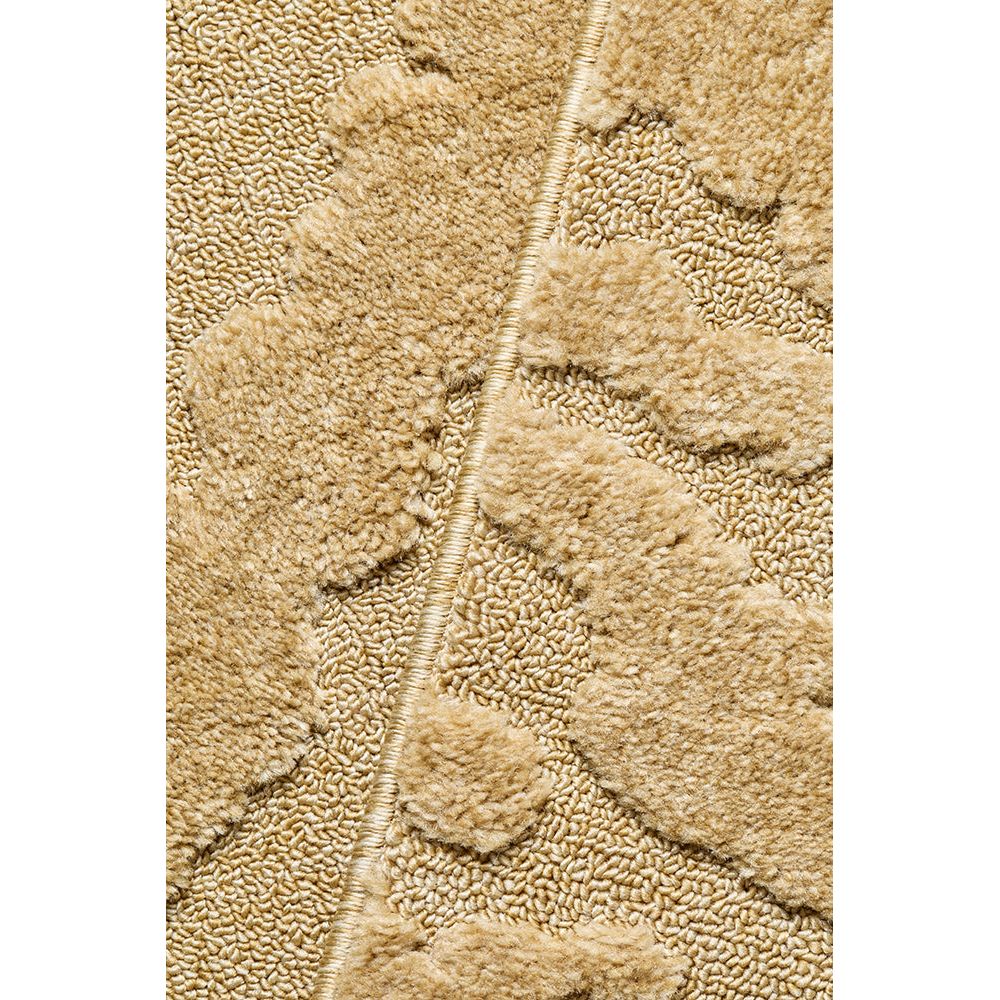Close-up of textured gold patterned rug