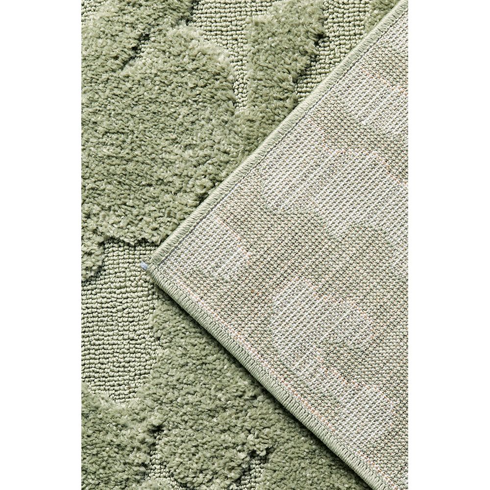 Close-up of a textured green runner rug with a geometric pattern