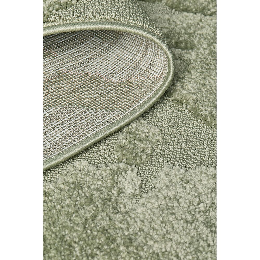 Close-up of a textured green rug corner