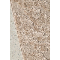 Textured beige rug on a concrete floor
