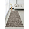 Long, textured brown mocha rug on a light gray floor in a living room setting with a white sofa and small table.