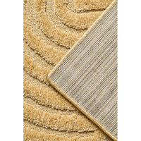 Close-up of textured gold coloured rug corner