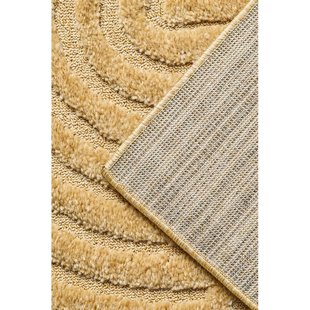 Close-up of a textured gold coloured rug corner