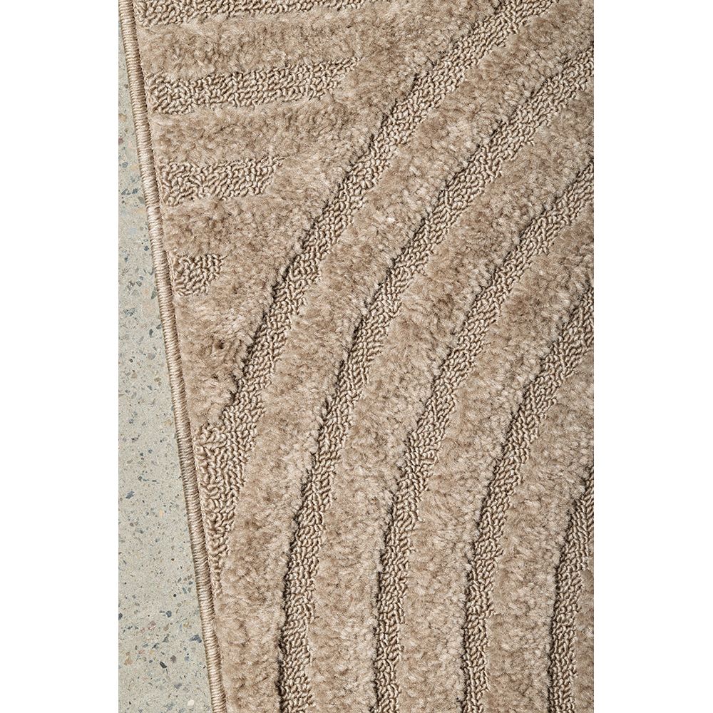 Close-up of a textured beige runner rug border on a light gray background