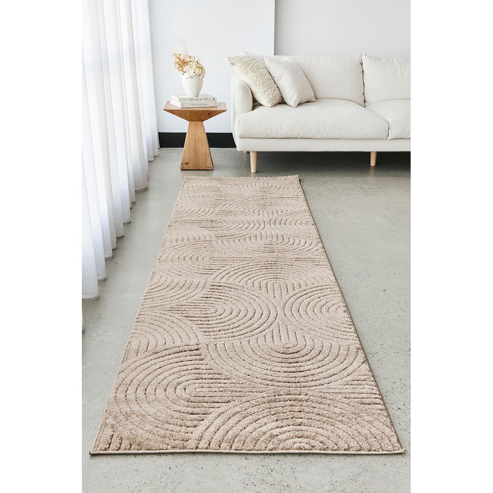Beige patterned runner rug on a light grey floor in a living room setting.