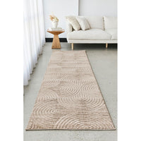 Beige patterned runner rug on a light grey floor in a living room setting.