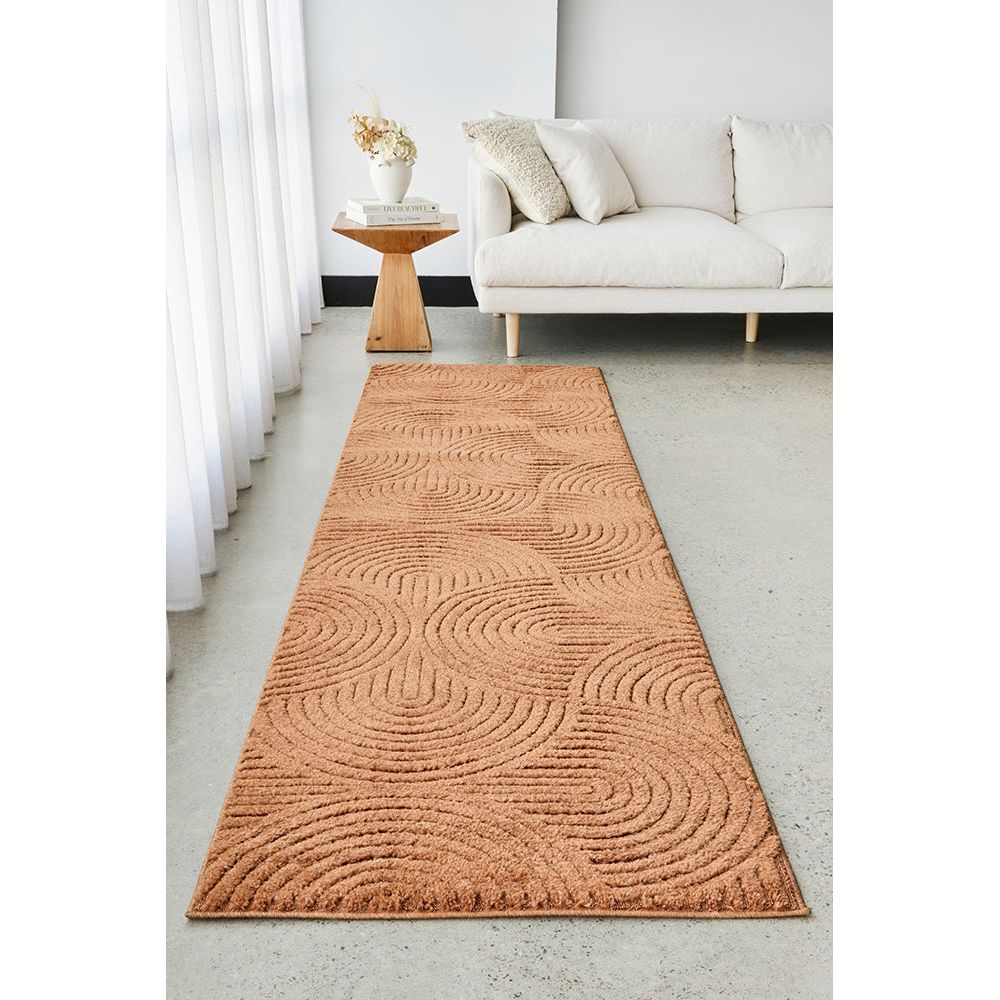 Rust textured runner rug on a light gray floor in a living room setting.