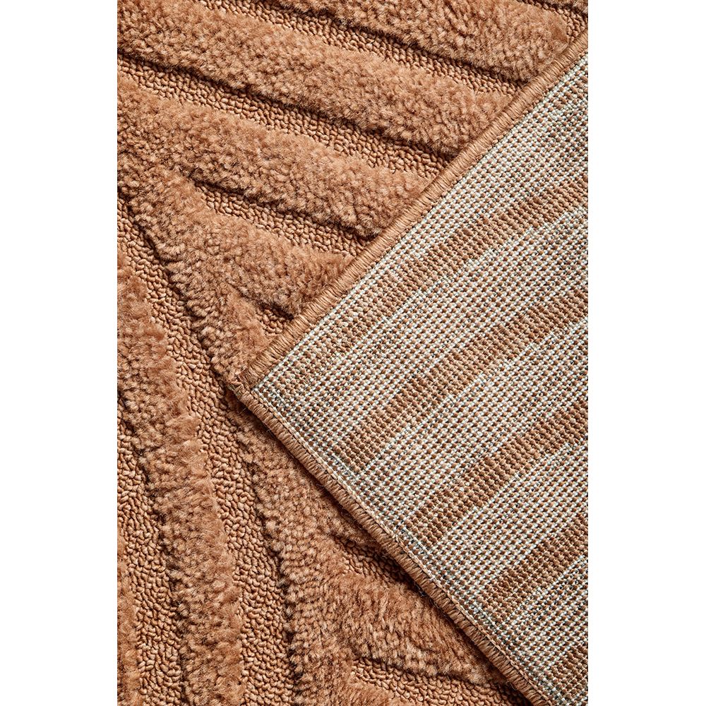 Close-up of a textured rust rug with a checkered pattern