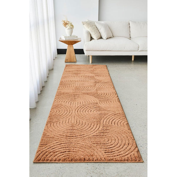Rust coloured textured runner rug on a light gray floor in a living room setting.