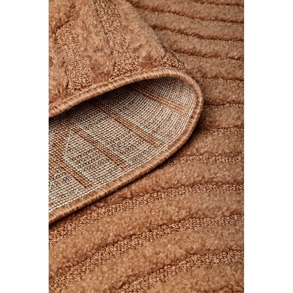 Close-up of a rust coloured textured rug with a checkered pattern