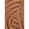 Close-up of a rust coloured textured patterned rug