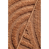 Close-up of a rust coloured textured patterned rug