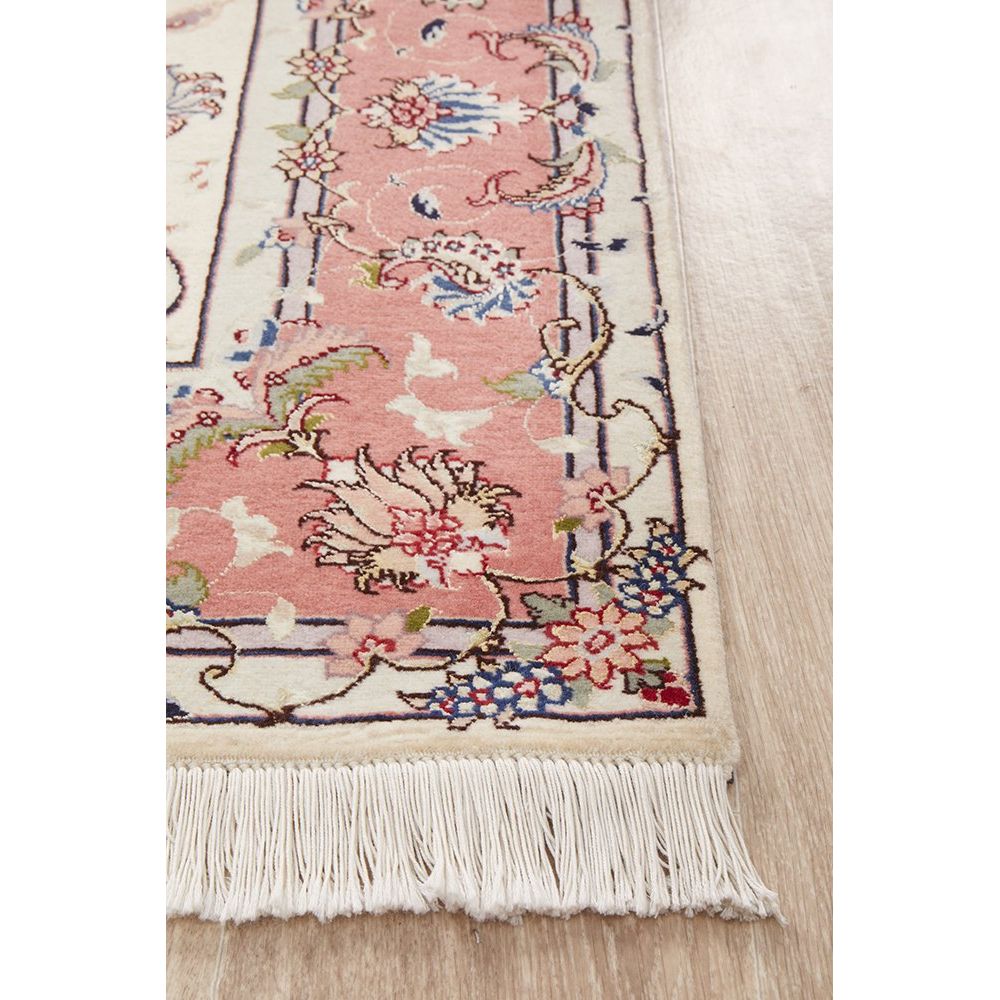 Decorative rug with floral and bird patterns on a wooden floor