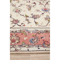 Close-up of a floral patterned rug with pink and blue colors.