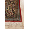 Decorative Hand Knotted Silk Rug with intricate patterns and fringes on a light wood floor.