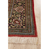 Decorative Hand Knotted Silk Rug with intricate patterns and fringes on a light wood floor.