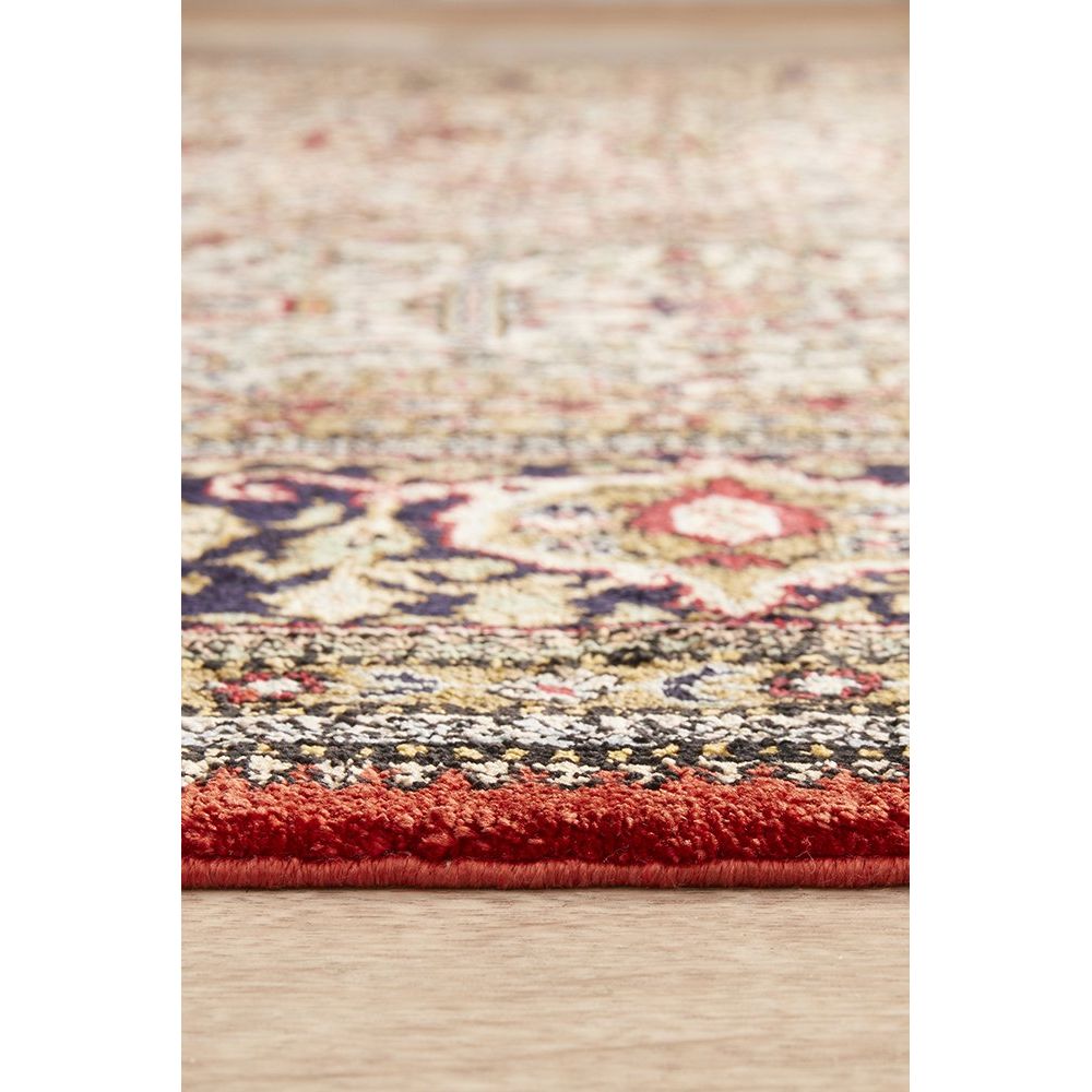 Multicolored patterned Hand Knotted Silk Rug on a wooden floor