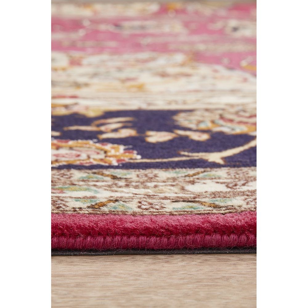 Close-up of a multicolored textured rug on a wooden floor.