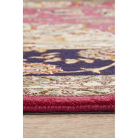 Close-up of a multicolored textured rug on a wooden floor.