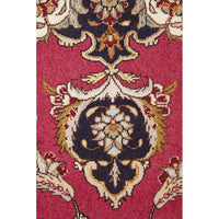 Close-up of a patterned Persian wool rug with intricate designs on a red background