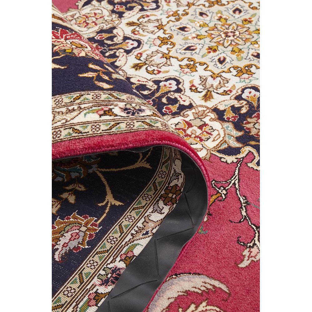 Close-up of a patterned Persian wool rug with intricate designs and vibrant colors.