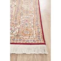 Close-up of a patterned Persian wool rug with fringes on a wooden floor