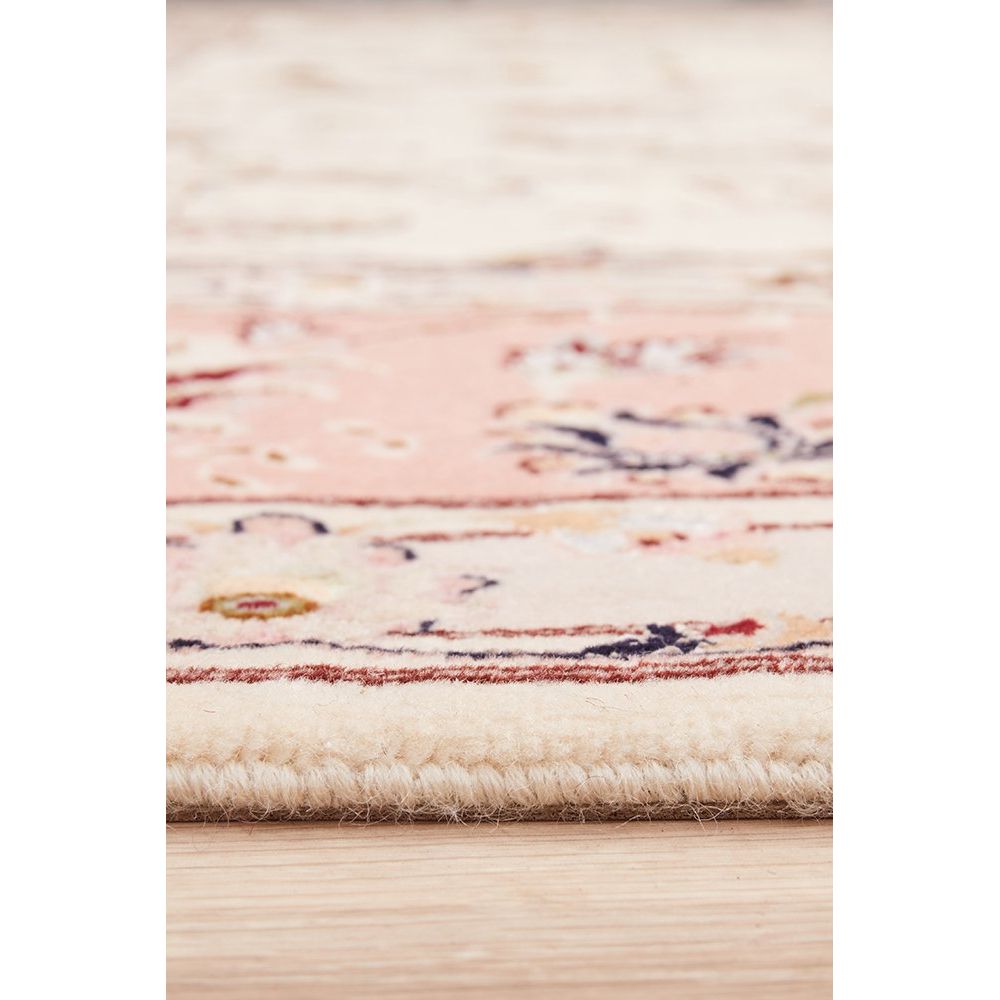 Close-up of a patterned Persian wool rug with floral patterns on a light background
