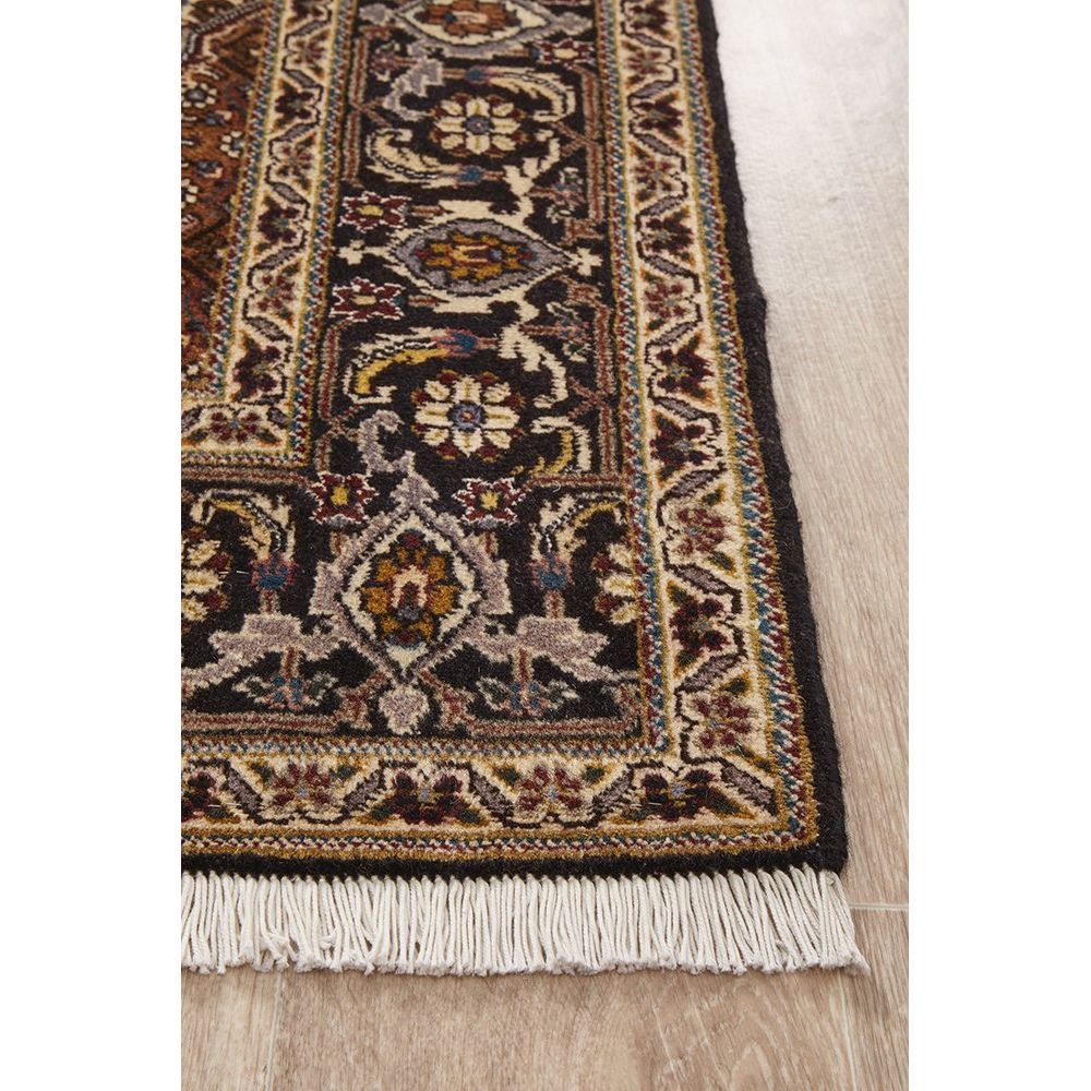 Decorative Persian wool rug with intricate patterns on a wooden floor