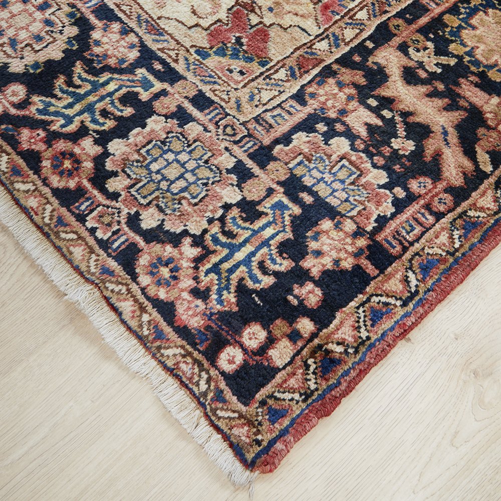 Decorative Persian wool rug with intricate patterns on a light wooden floor
