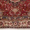 Close-up of an intricately designed Persian wool rug with red, grey, and beige colours.