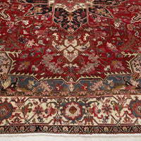 Close-up of an intricately designed Persian wool rug with red, grey, and beige colours.